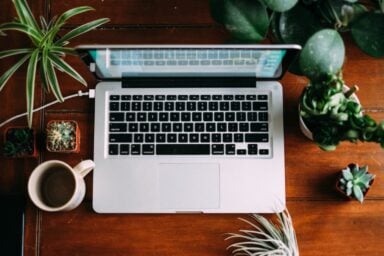 An open laptop sits on a desk, illustrating the convenience and accessibility of online therapy.